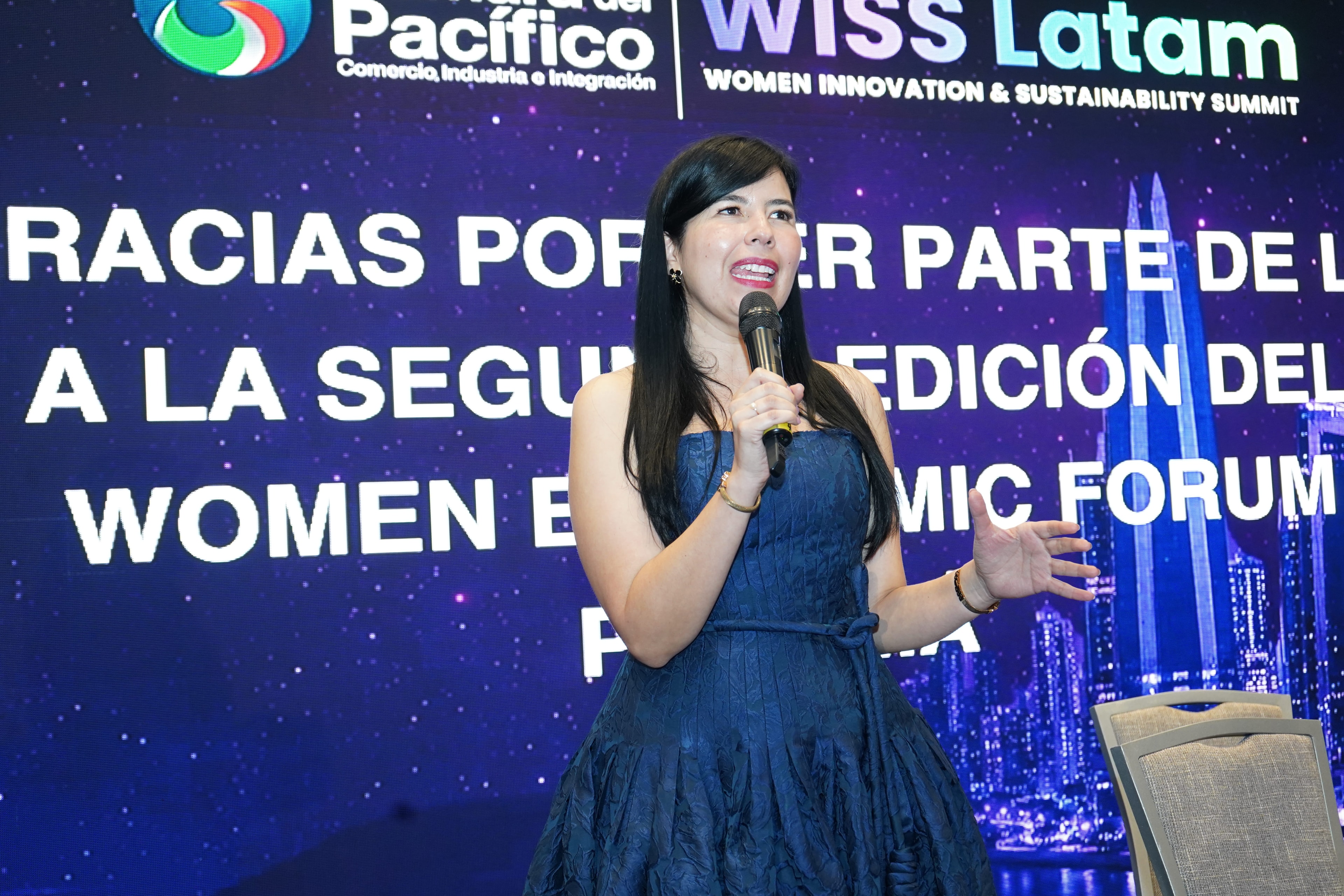 Mujer con micrófono hablando frente a pantalla "Gracias por ser parte de la segunda edición del Women Economic Forum Panamá" — Cámara del Pacífico y WISS Latam — Foro 27 Ago 2026